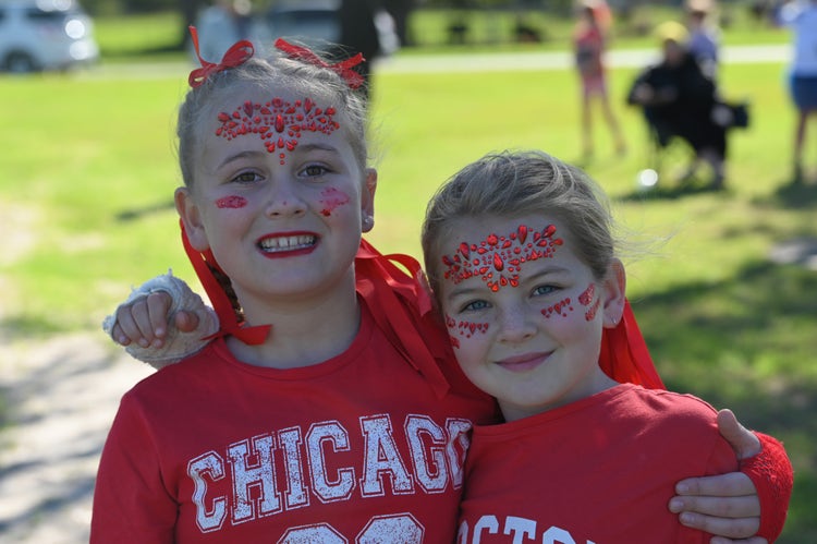 two students hugging wearing red