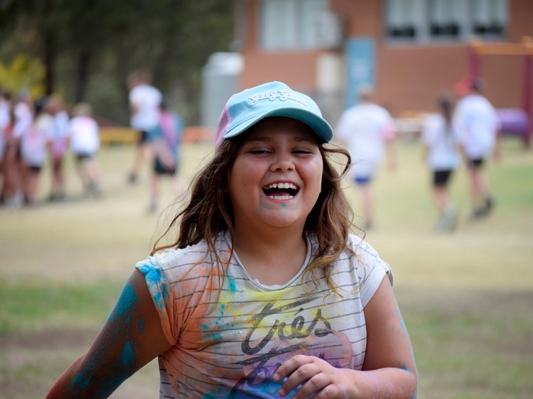 student smiling after colour run